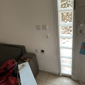 מד מתח מחובר לשקע חשמלי בקיר