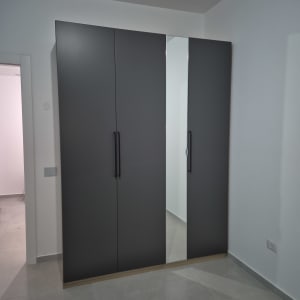 ארון בגדים אפור עם דלתות ומראה