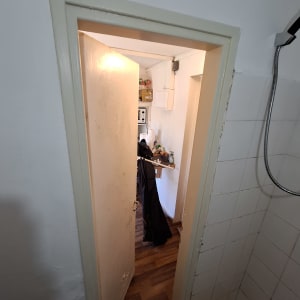 דלת פתוחה עם קיר צבוע ולוח עץ