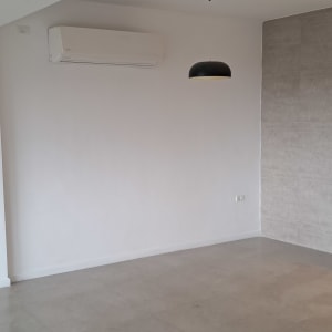 קיר צבוע בלבן עם מזגן תלוי