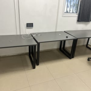 שולחנות ריקים עם כיסא משרדי וחוט חשמל