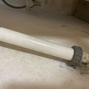 צינור פלסטיק עם מחבר מתכת על רצפה