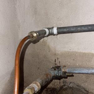 צינורות מתכת עם חיבורים והברגות בקיר