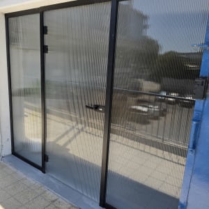 דלת זכוכית עם מסגרת מתכת שחורה