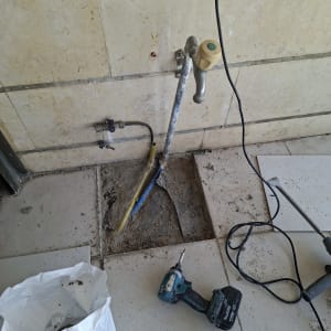 כלי עבודה וצנרת בתהליך תיקון על רצפה