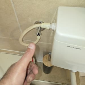 חיבור צינור למיכל הדחה בשירותים