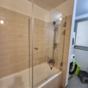 אמבטיה עם דלת זכוכית ומקלחת יד