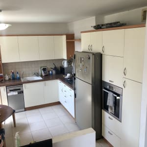 מטבח עם ארונות לבנים, מקרר ותנור בילט אין