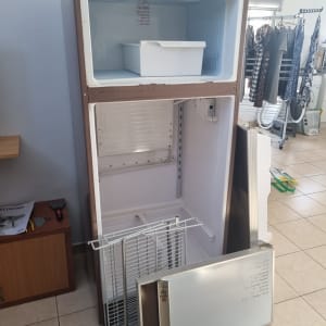 מקרר פתוח עם מדפים וכלים מסביב