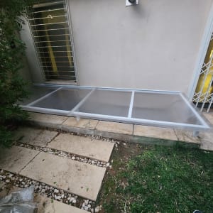 מסגרת אלומיניום עם לוחות שקופים על הקרקע