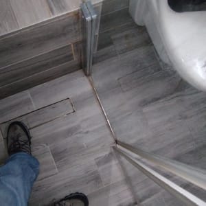 רצפת מקלחת עם דלת זכוכית ומדרגה