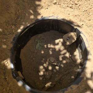 בור באדמה עם צינור וחלקי מתכת