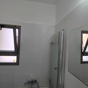 חדר אמבטיה עם אריחים מעוצבים וברזים מודרניים