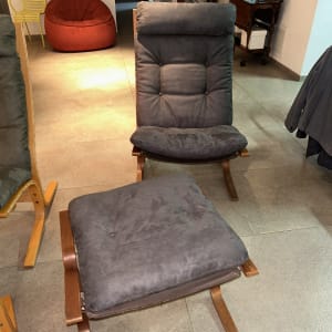 כורסה עם ריפוד אפור ומושב תואם על רצפה