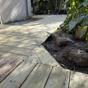 דק עץ ליד צמחים בגינה