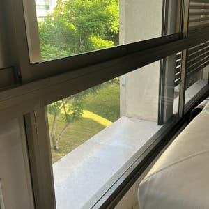 חלון זכוכית עם נוף לעצים ובניינים
