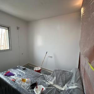 חדר צבוע עם כלי צביעה ויריעות פלסטיק