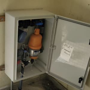 מערכת השקיה עם מסנן כתום בתוך ארון