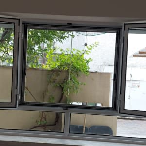 חלון אלומיניום פתוח עם נוף חיצוני