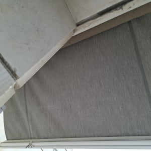 סוכך אפור עם מסגרת מתכתית מותקן על קיר