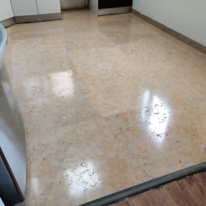 רצפה נקייה ומבריקה במטבח עם ארונות לבנים