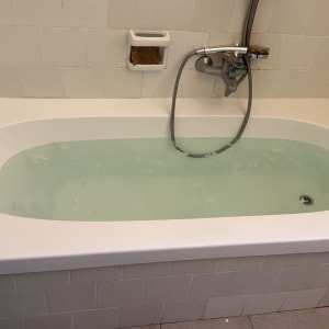 אמבטיה עם חיפוי אריחים ולחצן מים