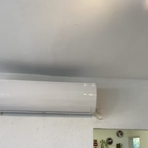 מזגן קיר לבן מותקן על קיר לבן