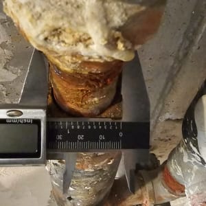 צינור חלוד עם מדידה בכלי עבודה