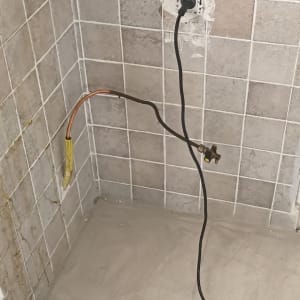 שקע חשמל וקיר עם אריחים שבורים
