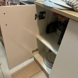 ארון מטבח פתוח עם כלים וספלים על המדף