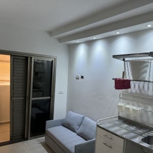 מטבח קטן עם כיור ומדפים מוארים