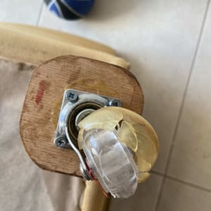 גלגל שבור מחובר לרהיט מעץ עם ברגים