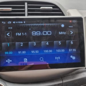 מסך רדיו ברכב מציג תדרים וכפתורי שליטה