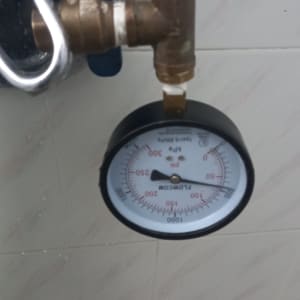 מד לחץ מים מחובר לצינור מתכת