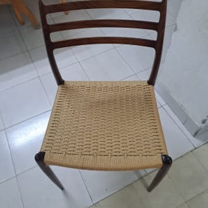 כיסא עם מושב קלוע מעץ על רצפת אריחים