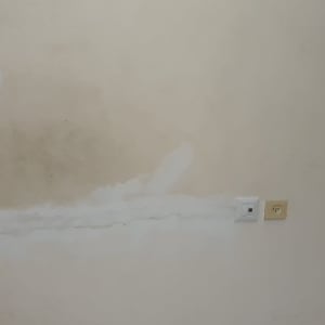 קיר עם תיקוני טיח ושקעים חשמליים