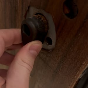 יד מחזיקה חלק מנעול בדלת עץ