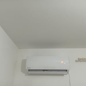 מזגן קיר לבן עם תצוגת טמפרטורה 28 מעלות