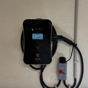 מטען לרכב חשמלי מותקן על קיר עם כבל חשמל