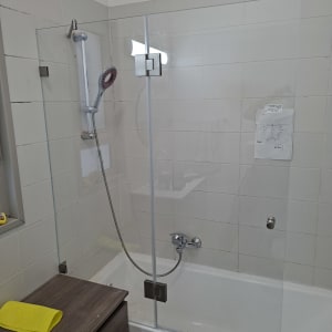 מקלחון עם דלת זכוכית ואביזרי מקלחת