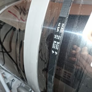 חגורת גומי שחורה על תוף מתכת במכשיר חשמלי