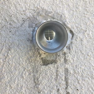 צינור מתכת עגול בקיר בטון