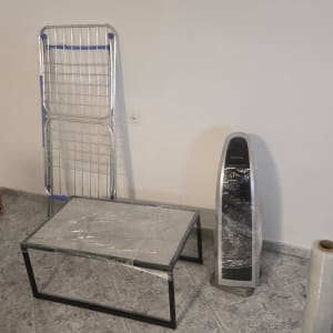 חדר עם רהיטים עטופים בניילון וציוד אריזה