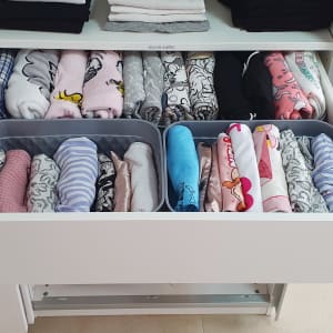 מגירות מאורגנות עם בגדים מקופלים בתאים נפרדים