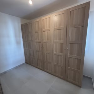 ארון עץ גדול עם דלתות בחדר ריק