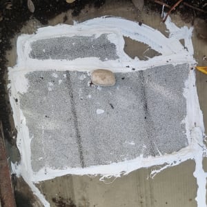 איטום עם חומר לבן על משטח אפור