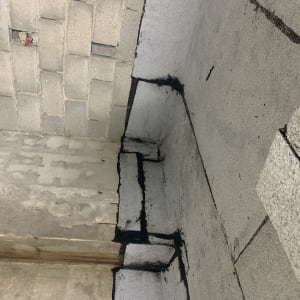 קירות בטון עם איטום שחור בפינות ובחיבורים