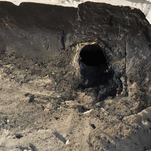 חור בקיר עם חומר איטום שחור מסביב