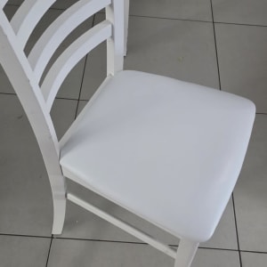כיסא לבן על רצפת אריחים אפורה