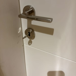 ידית נירוסטה ומפתח מותקנים בדלת פנים לבנה